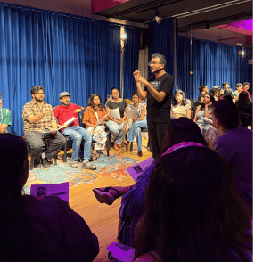 Varun Gwalani moderating a seated event audience